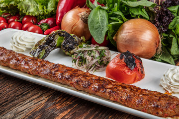 Minced lamb kebab with vegetables ( Turkish Cuisine Adana Kebab ).