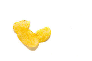 Potato crisps isolated on a white background. Chips lie on a white background. Concept of eating delicacies, relaxation. Unhealthy food causing overweight and cholesterol problems.