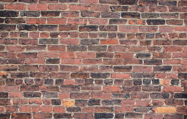 Brick industrial wall, excellent background. Color and detail in this beautiful vintage brick wall, built years ago. Cracked and aged surface of textured brick wall. 