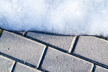 Paving slabs on walkway with ice.