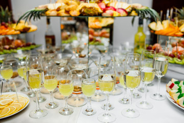 Champagne glasses. Delicious sweet buffet with cupcakes sparkling wine in party.