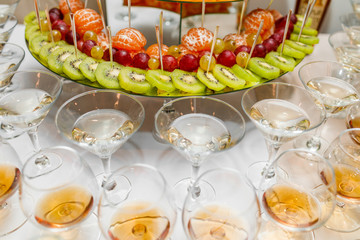 Champagne glasses. Delicious sweet buffet with cupcakes sparkling wine in party.
