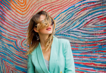 Young woman in Blazer of 90s style and sunglasses