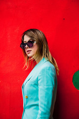 Young woman in Blazert of 90s style and sunglasses