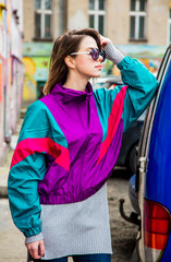 woman in jacket of 90s style stay at counrtyard of house