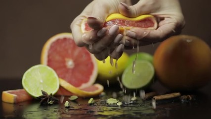 Woman squeezing a fresh and juicy grapefruit with hands. Fresh fruits