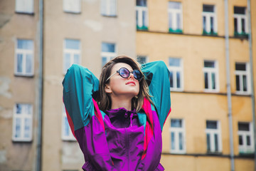 Young woman in jacket of 90s style stay at  back yard