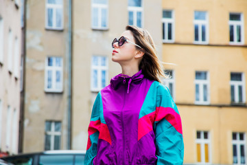 Young woman in jacket of 90s style stay at  back yard