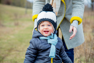 Young mother with toddler boy at outdoor.