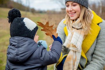 Young mother with toddler boy at outdoor.