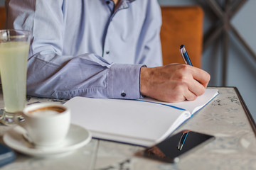 Middle aged businessman working in a coffee shop