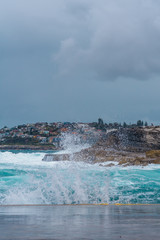 beautiful seaside landscape during hazy day, coastal town, crushing waves