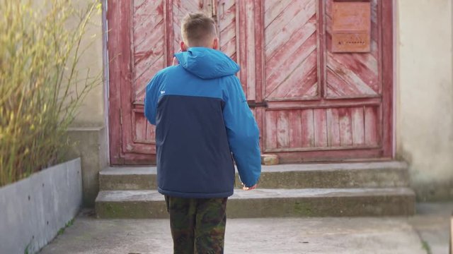 An angy teenager speaks by mobile and smashes a mobile phone