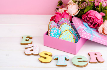 Colorful easter egg in gift box, cookies biscuits letter Easter on wood background.
