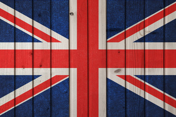 Flag of Great Britain on the background of wooden boards. Wallpaper for installation and design. Space for text.