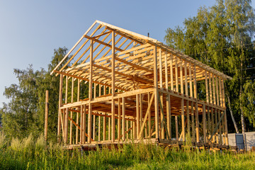 wooden interior frame of a new house under building, architectural residential construction stick built home framework.