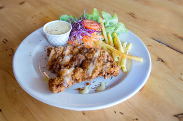 Chicken fried steak with country gravy and french fries. Pork chop, French fries and vegetables. Homemade Country Fried Steak with Gravy and Potatoes 