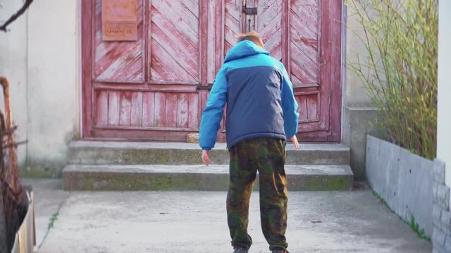 A boy speaks by mobile phone, gets angry and smashes a mobile phone