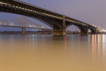 Large steel bridge crossing the mighty Mississippi River in urban St. Louis