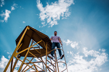 Man standing calmly on round metal construction