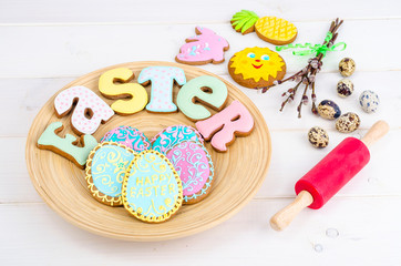 Fototapeta na wymiar Homemade Easter pastry in shape of letters and eggs on wooden background.