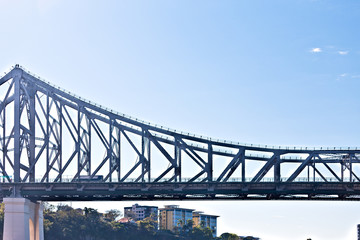 Long and metal bridge with shiny blue sky
