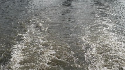 Ship wake on the river, Water foam trace behind the large ship goes, high speed camera, slow motion.