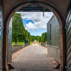 View of the Baroque style formal garden through the open gate.Frederiksborg Castle.Denmark