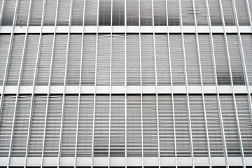 closed blinds on modern building facade, closed shutters on office exterior