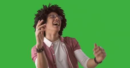 Man with curly hair dancing over chroma key green background