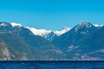 Fototapeta na wymiar Burrard Inlet, ocean and island with mountains in beautiful British Columbia. Canada.