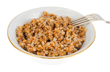 Buckwheat porridge in white plate, vegetarian dish