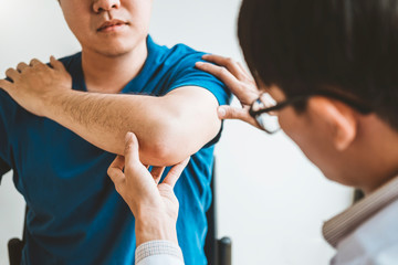 Physical Doctor consulting with patient About elbow muscule pain problems Physical therapy diagnosing concept
