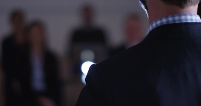 4K Closeup View From Behind Of Businessman Giving Speech At Business Conference