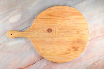 Wooden cutting board on a gray marble background