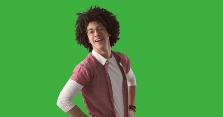 Man with curly hair posing and trying different looks over green chroma key background