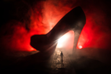 Artwork decoration. Silhouette of a man standing in the middle of the road on a misty night with...