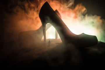 Artwork decoration. Silhouette of a man standing in the middle of the road on a misty night with...