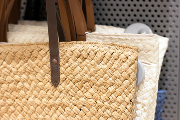 Straw trend bags close-up in the store, front view