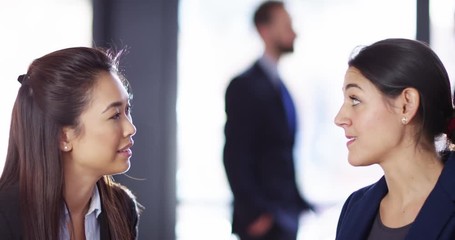 4K Business people chatting at conference, focus pull from background to fore