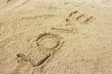 Love word written on the sand at the beach, natural background of love symbol