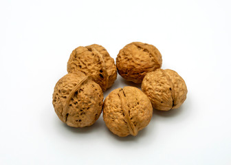Five Walnuts Isolated on a White Background.