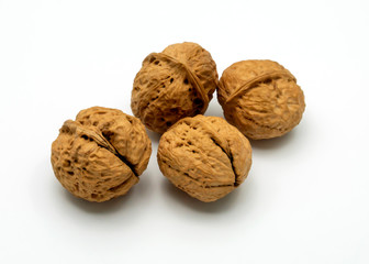 Four Walnuts Isolated on a White Background.