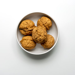The Walnuts in White Bowl Isolated on a White Background.