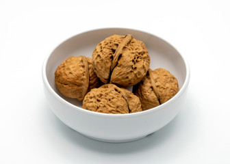 The Walnuts in White Bowl Isolated on a White Background.