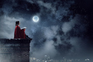 Super hero on roof. Mixed media