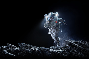 Fototapeta na wymiar Spaceman running fast. Mixed media
