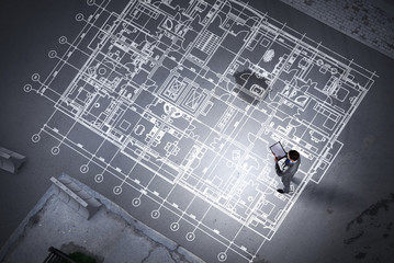 Man engineer thinking over his plan. Mixed media