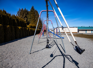 Empty school playground swing set