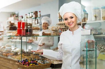 Women at confectionery shop with pastry.